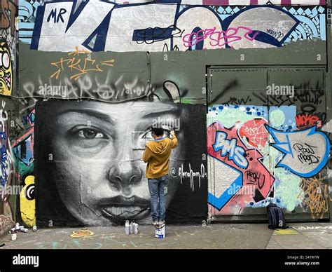 A Graffiti Artist Paints An Artwork On The Southbank In London England