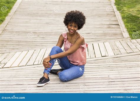 Portrait Of A Happy Young Beautiful Afro American Woman Sitting Stock