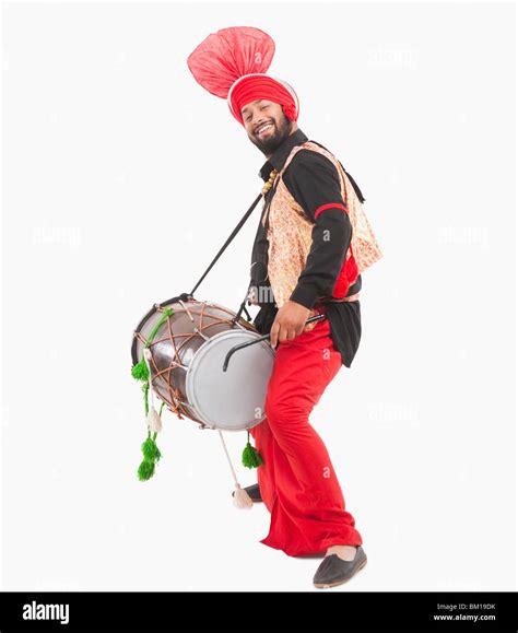 Man performing Bhangra dance with a dholak Stock Photo - Alamy