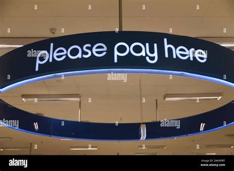 Signage In A Large Department Store Directs Customers To The Checkout