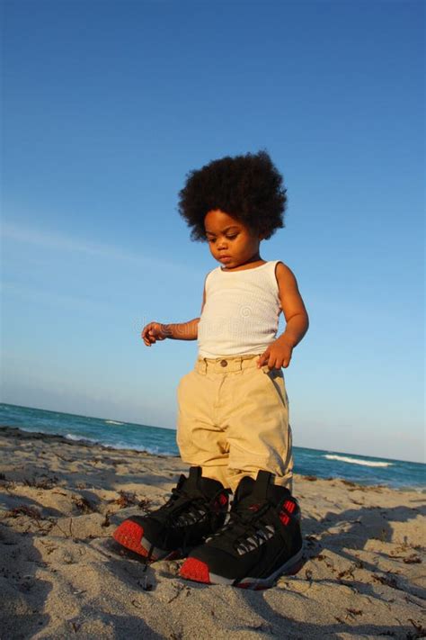 Toddler in Big Shoes stock photo. Image of size, sand - 5123880