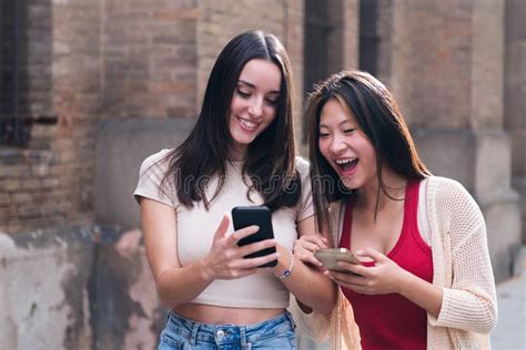 Women Laughing Funny Looking At Their Cell Phones Stock Image Image