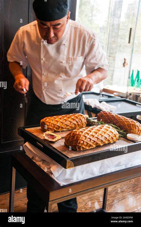 A Chef Carving A Beef Wellington Rossini As Served At A Lunch In Pulis