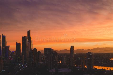 Dramatic Orange Sunset Over The Coastline And Buildings Of Surfers