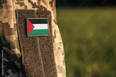 Close up millitary woman or man shoulder arm sleeve with Palestine flag ...