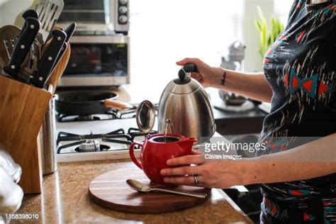 Woman Pouring Boiling Water Photos And Premium High Res Pictures