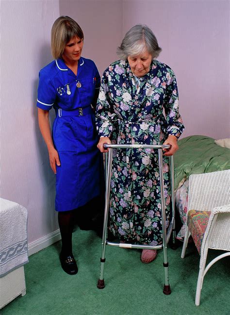 District Nurse Helps Old Woman Use Walking Frame 1 By Chris Priest Science Photo Library