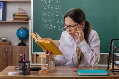 Free Photo Young Woman Teacher Wearing Glasses Holding Book Preparing