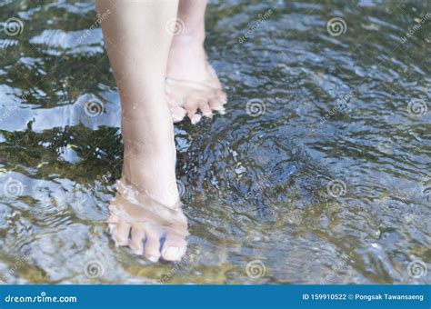 Woman Feet Walking On The Water In The River For Relax Feeling Stock