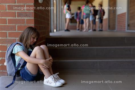 Side View Of A Caucasian Schoolgirl Wearing Denim Shorts Sports Shoes