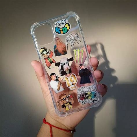 Someone Holding Up Their Phone Case With Stickers On It