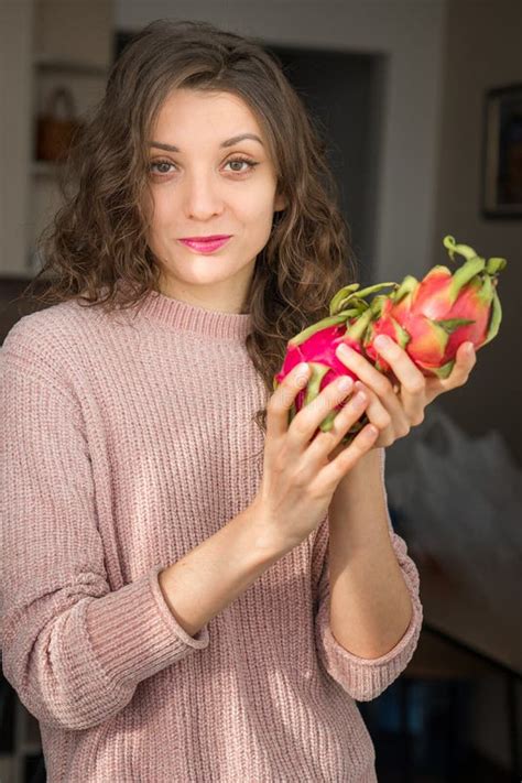 Young Girl Is Holding Two Fresh Ripe Organic Dragon Fruits Or Pitaya