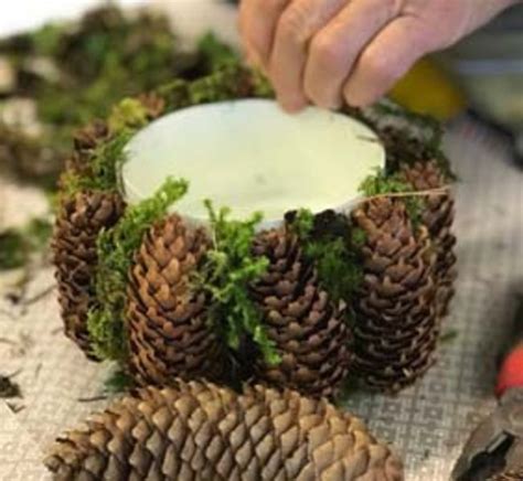 Someone Is Decorating A Pine Cone Wreath