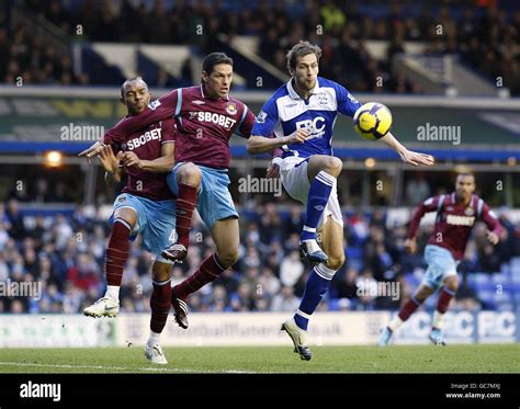 Birmingham City S Roger Johnson Right Has A Shot On Goal Which Is