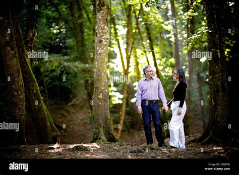 couple  woods surrounded  nature holding hands happy smiles