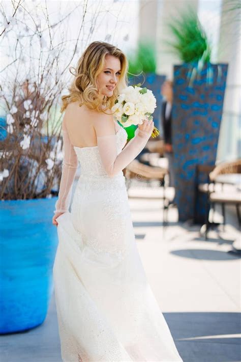 Beautiful Blonde Bride In A Tight Fitting Dress With A Bouquet Stock Image Image Of Ceremony