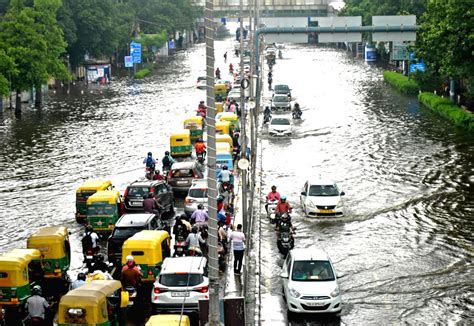 Vehicles Wade Through A Waterlogged Road