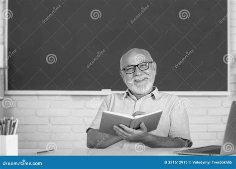 Man Mature Teacher Portrait Of Happy Senior Tutor In Glasses With Book On The Blackboard In