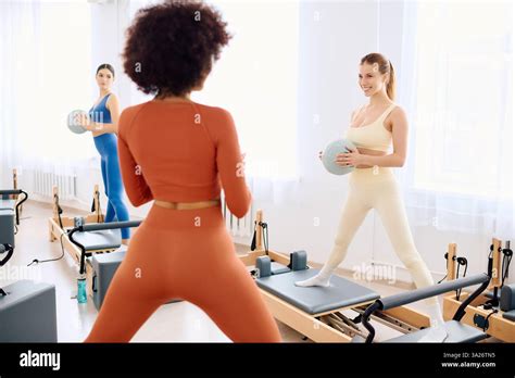 Participants do precise pilates exercises to boost strength and flexibility Stock Photo - Alamy
