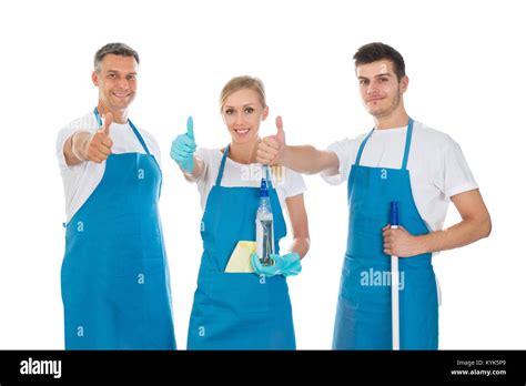 Portrait Of Happy Janitors Showing Thumb Up Sign Against White