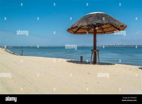 Straw Parasol On Tropical And Paradisiac Beach In Angola Stock Photo