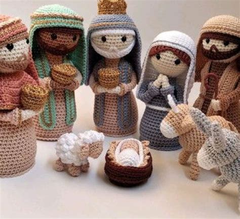 Crocheted Nativity Figurines Are Displayed On A White Surface