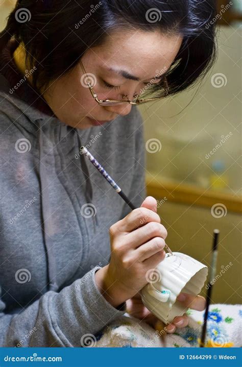 Woman painting pottery editorial stock image. Image of female - 12664299