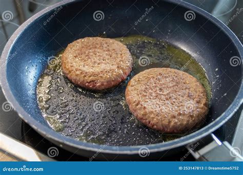 Two Burger Patties Burger Meat Sizzling In Hot Pan With Fat And Oil As Delicious Selfmade