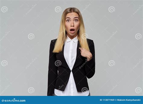 Business Cute Blonde Woman With A Shocked Face Opens Her Mouth And Eyes Wide In Surprise And