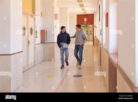 Couple Gay College Student Friends Walking Down A Hallway In Contact Stock Photo Alamy
