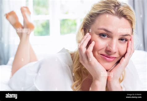 Pretty Blonde Lying On Bed Smiling At Camera Stock Photo Alamy