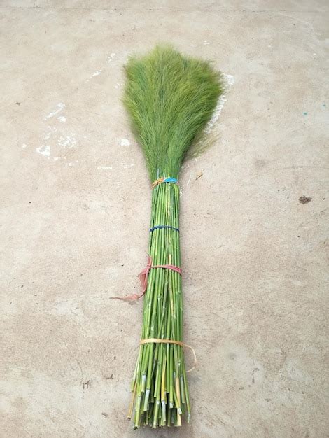 Premium Photo | Grass broom on the concrete floor