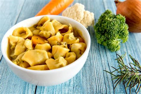 Premium Photo | Cappelletti soup and vegetables cappelletti italian ...