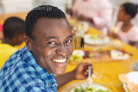 Portrait Of Smiling African American Mid Adult Man Having Lunch With