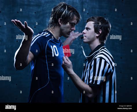 Studio shot of referee showing red card to soccer player Stock Photo ...