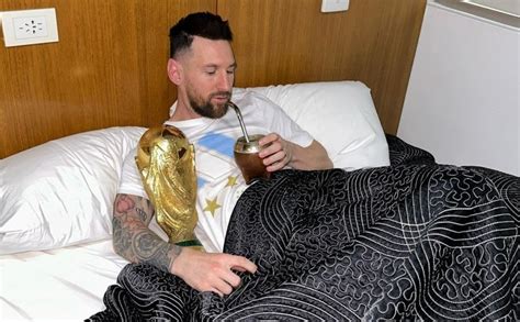 Lionel Messi wakes up embracing World Cup trophy.