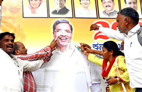 Supporters of senior Congress leader Siddaramaiah perform 'abhishek' of ...