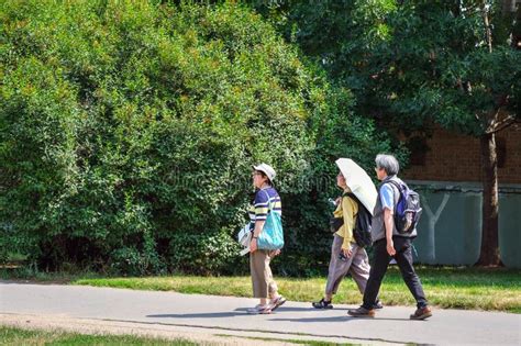 Asian Tourists Are Walking During A Hot Day In Prague Editorial Photo Image Of Lady