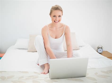 Premium Photo Natural Happy Blonde Using Laptop While Sitting On Bed
