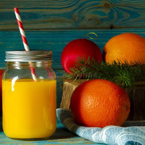 Glass Jar Of Fresh Orange Juice With Fresh Fruits On Wooden Table Stock