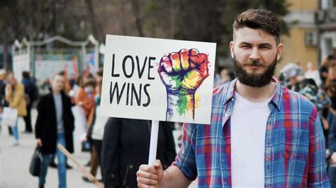 Love Wins Lgbt Rainbow Banner With Fist Gay Man Hold Lgbtq Protest Placard Stock Image Image