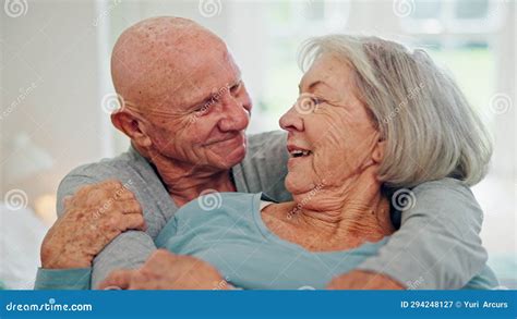 Senior Couple Hug And Kiss In Bedroom Care And Conversation Together