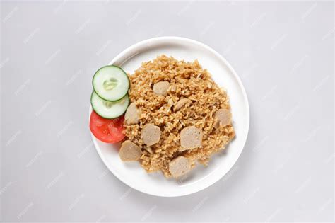 Premium Photo | Nasi goreng bakso is fried rice with meat ball garnished with fresh cucumber and ...