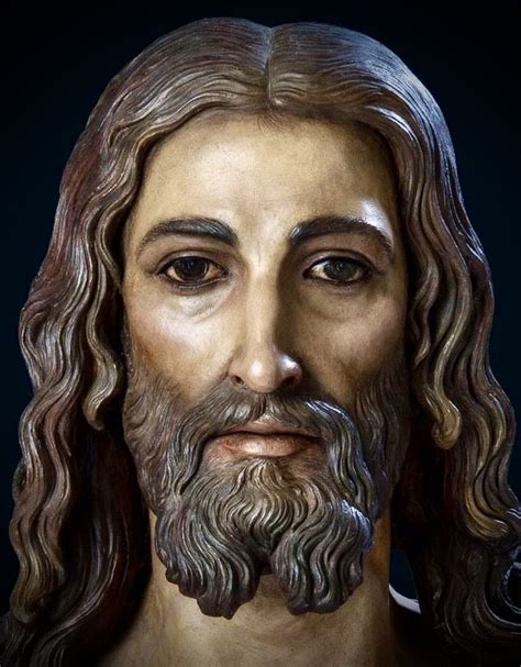 A Statue Of Jesus With Long Hair And Beard