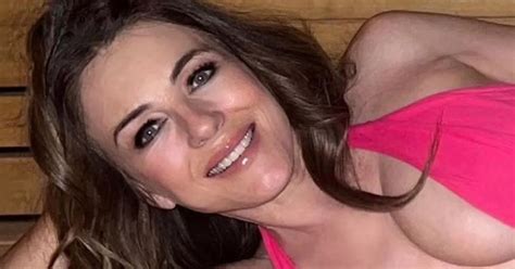 Liz Hurley 58 Dubbed MILF As She Rolls Around In Tiny Pink Thong Bikini For Racy Snaps