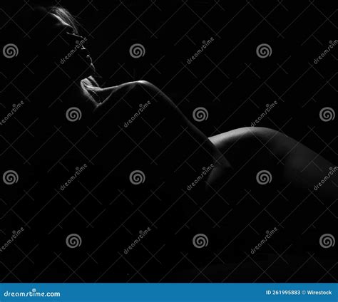 Beautiful Black And White Shot Of A Nude Woman With Curves In A Dark Background Stock Image