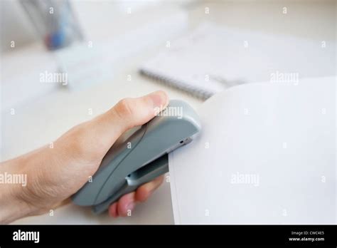 Close Up Of Mans Hand Stapling Paper In Office Stock Photo Alamy