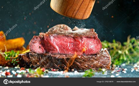 Close Up Of Tasty Beef Steak On Black Stone Table Stock Photo By