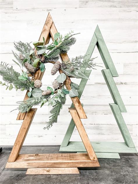 A Wooden Christmas Tree With Pine Cones And Greenery In The Shape Of A