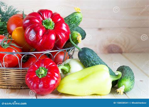 Fresh Harvested Washed Vegetables In Wicker Basket On Wooden Table With